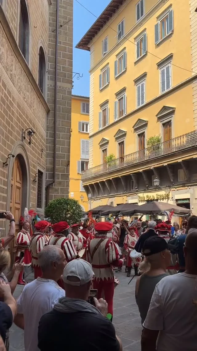 A centuries old tradition in Florence Italy that Henry III said was, “too small to be a real war and too cruel to be a game!”
The Calcio Storico Fiorentino is an annual city sporting match full of tradition and pride since the 1500s.
Today I stumbled upon a peek of the participants preparing for tonight’s big match. 
The Calcio Storico Fiorentino is a combination of soccer, rugby, wrestling and street fighting. Originally invented by rich aristocrats and only played by the higher social class but now men (citizens) from across Florence proudly participate either on the field, in the drum corps or as a flag bearer, and still played in the historical (and heavy & hot) costume. 
Four teams made up of 27 players and various attendants from the 4 historic neighborhoods of the city compete against each other, first in two semi-finals and then the final match to determine the winner. The winning prize for these fierce sportsman  was originally a Chianina calf but now they enjoy a free celebratory dinner at a restaurant. Today i saw the opening ceremony and parade of the semi final day match as they left their medieval headquarters in the old part of Florence city center to march the streets full of pride & anticipation, eventually arriving into Piazza Santa Croce. There the arena stands are in place and 1000s of tons of dirt have been brought in to cover the stone piazza as they have for 100s of years. For most years it was played in the Piazza della Signoria.
The sport lost favor in the 1700s but in the 1920s was revived and even now though extremely violent and competitive, a few rules have been changed in modern times to prevent deaths. 
Still today after nearly 450 years, punches still fly, teeth are lost and scars are created all in the name of neighborhood pride & Florentine tradition! 
#CalcioStoricoFiorentino
#florenceitaly #firenze 
#italiantradition #italianpride